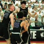 The North Kitsap boys basketball team celebrates after pulling off an improbable comeback in the semifinals in the 2A state tournament against Lynden. (File photo)