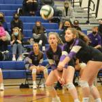 Allie Kelley comes up with a bump while Emma Stephens watches.