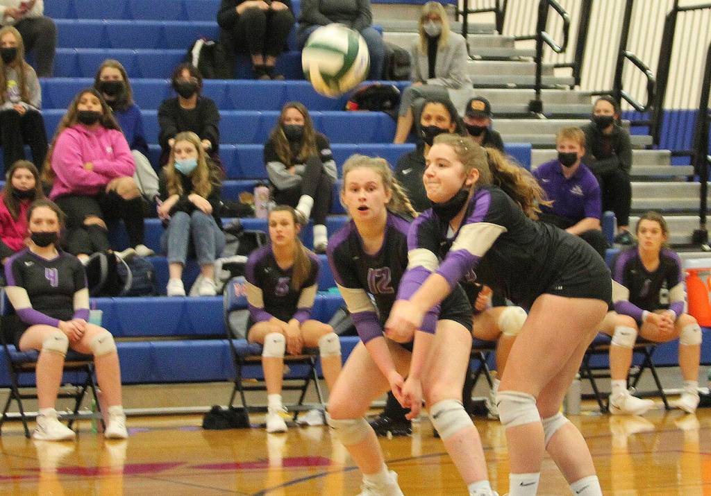Allie Kelley comes up with a bump while Emma Stephens watches.