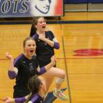 Maddie Pryde and Sophia Baugh celebrate winning a point.