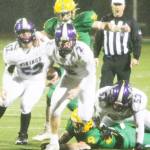 With the strong winds, Viking quarterback Colton Bower (2) was more effective running the ball in the first half. Here Quinn Knivila- Ruchie (52) and Jesus Mares (53) block for him. Steve Powell/North Kitsap Herald photographs