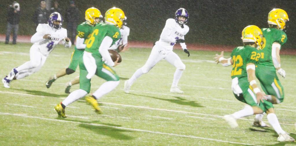 Zeke Harris (4) and Morgan Paul (3) of North Kitsap try to chase down Lynden wide receiver Kaleo Jandoc in Saturdays game.