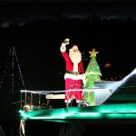 Santa waves from his boat during the 50th Lighted Ships Parade in 2019. Herald file photos