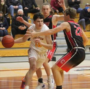 Kingstons Dakota Standley (12) drives the baseline against a Crosspoint double team. Steve Powell/North Kitsap Herald photographs