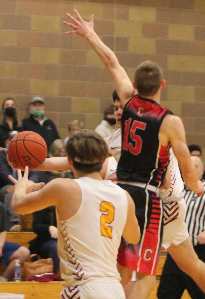 Buc Dakota Standley, partially hidden, passes around an opponent to teammate Caden Krantz (2) against the Warriors.