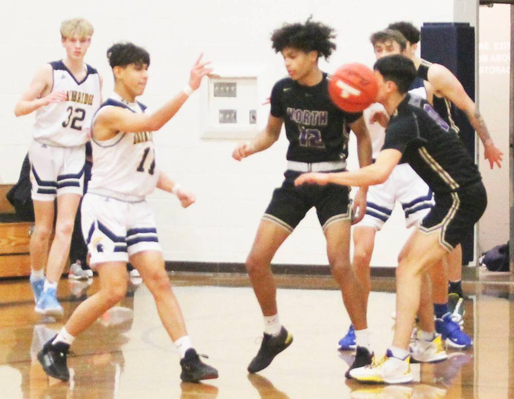 Spartan Breno Oguri (11) passes the ball in the North Kitsap game, while Harry Davies (12) defends and teammate Sam Nyland (32) looks on.