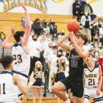 Cade Orness (10) drives to the hoop and puts up a short runner against James Carey (23) of Bainbridge. Breno Oguri (11) and Everett Moore (21) also defend. Steve Powell/North Kitsap Herald photos
