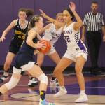 Grace Colburn (20) of Bainbridge drives to the hoop with Ayanna Selembo of NK defending.