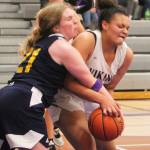 Maliyah Reed, right, fights with Ana Byers (21) of Bainbridge in the game.