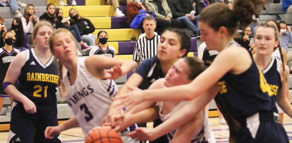 Vikings and Spartans collide trying to grab a loose ball.
