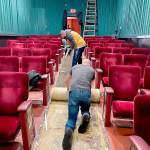 Volunteers roll up the aisle carpet runner in the newly renamed Historic Polaris Theatre that was soiled by recent water leakage. The Bay Street building once housed Port Orchard movie houses of various names  most recently the Dragonfly Cinema. (Facebook photo)