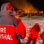 The fire marshal observes at the scene.