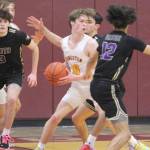 NKs defense sets the stage for its high-scoring offense. Here, Aiden Olmstead (3), Harry Davies (12) and Colton Brewer put pressure on Kingstons standout guard Zach Mead (10). Steve Powell/North Kitsap Herald photos