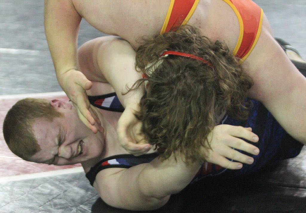 Treavor Atkins of Lindbergh grimaces as Gavin Garner of Kingston holds him down.