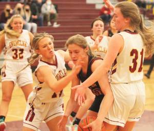 Eilee Brockman of Kingston is surrounded by Enumclaw Hornets after making a move inside. Steve Powell/North Kitsap Herald photographs