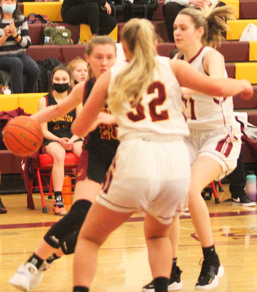 Buc Eilee Brockman gets set to drive between two Hornet defenders on the way to the hoop.