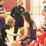 Coach Karla DeVries talks to the team in their playoff win over Renton.