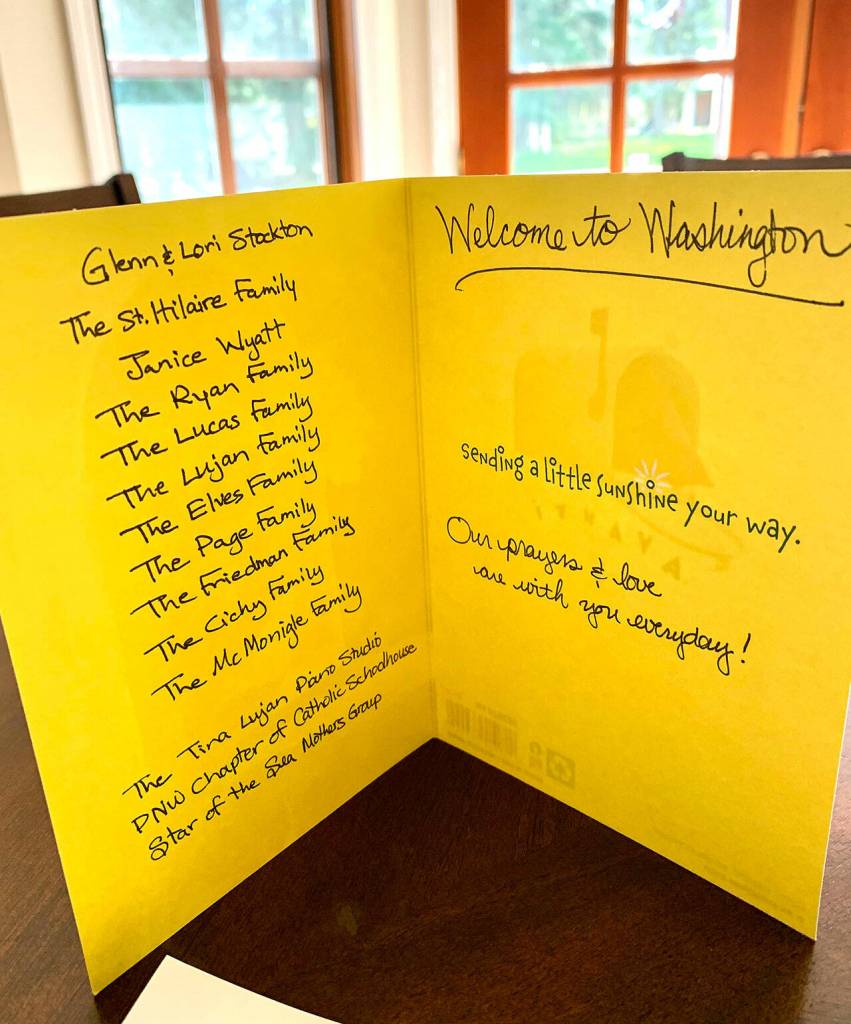 A greeting card from 10 of Alexandra Kusheretss Southworth neighbors welcomes her sisters family to the United States. The families generously provided bicycles, helmets, clothing, bedding and gift cards for Dasha Kusheretss young sons as they seek to get integrated into American life. The Ukrainian familys future is clouded, however.