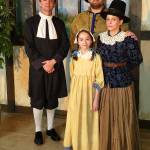 John Hemphill as Reverend Paris (left, back row), Greg Heilman as Thomas Putnam (right, back row), Nancy Nucci as Ann Putnam (far right, front row), and Alyssa Kusherets as Ruth Putnam (center, front row) star in Western Washington Center for the Arts production of The Crucible. (WWCA photo)