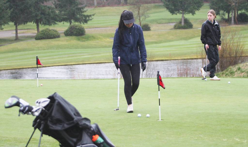 Hailey Fink and Myla Miller of Bainbridge practice putting prior to the match against Kingston.