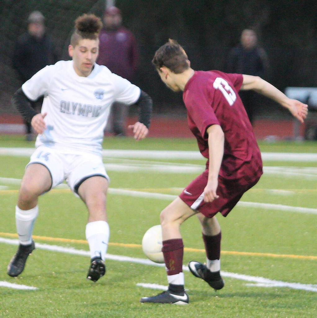 Gabriel Chamberin makes a move to dribble past an Olympic defender.