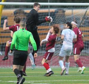Kingston goalie Carter Krantz jumps up to make a save under crowded conditions against Olympic. Krantz and the Bucs shut out the visitors 1-0. Krantzs booming kicks also were a powerful offensive weapon for the Bucs, keeping Olympic on the defensive side of the field. Steve Powell/North Kitsap Herald photos