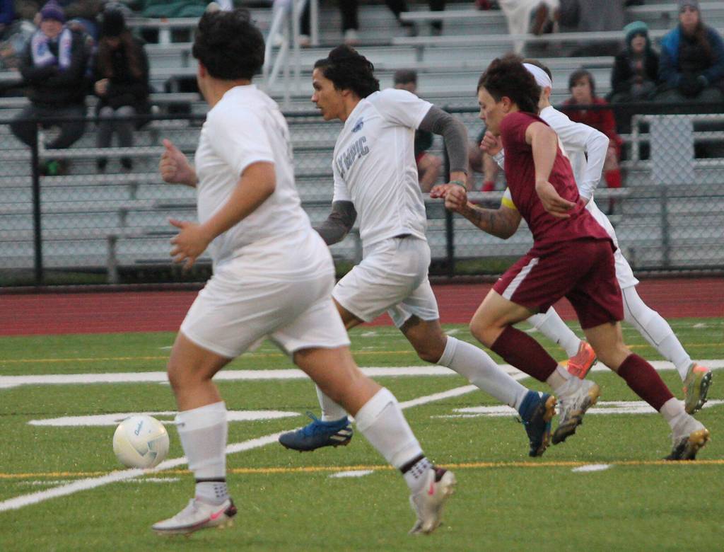 Kingstons Kaden Schaefer tries to outrace three Olympic players to the ball.