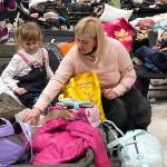 A mother and daughter wait in a refugee center in Poland.