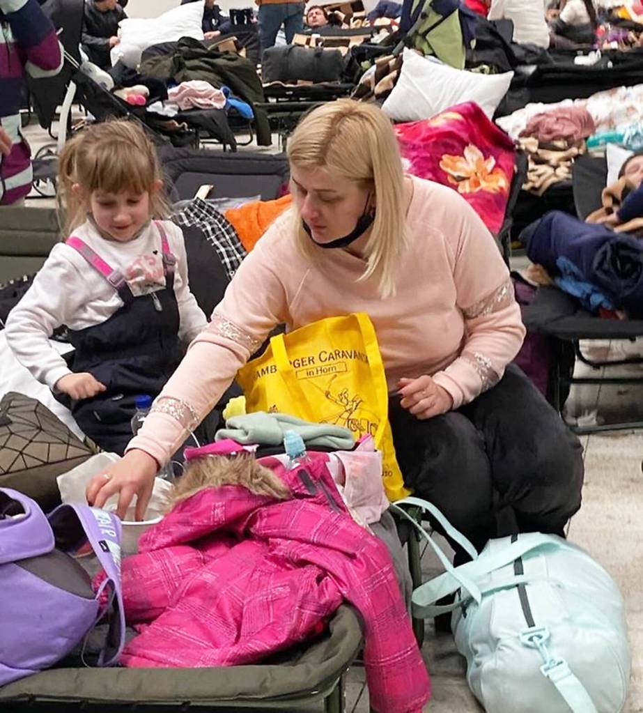 A mother and daughter wait in a refugee center in Poland.