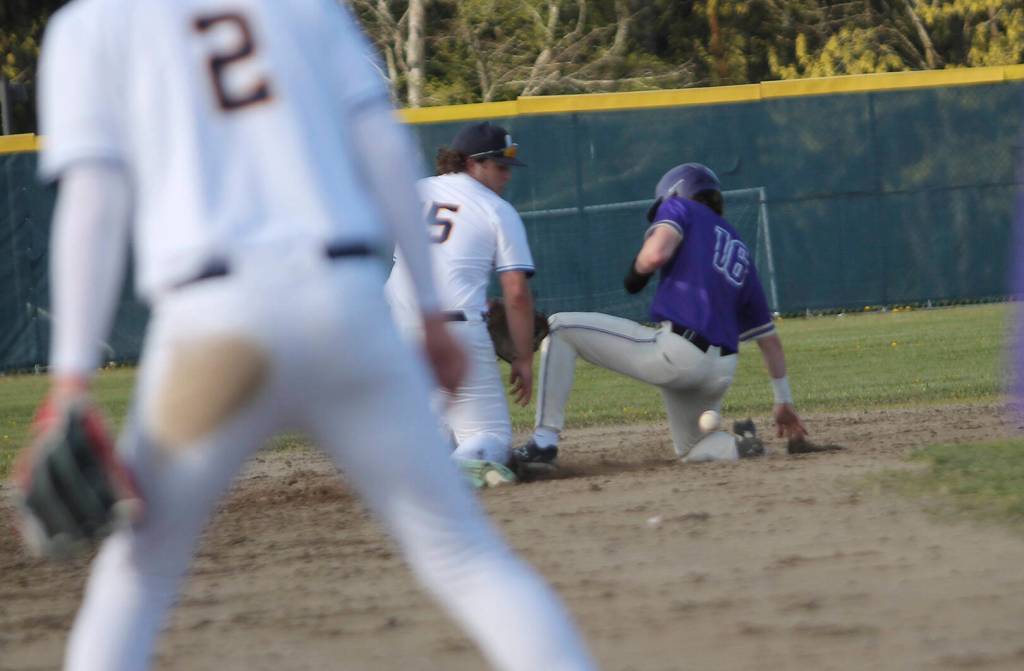 North Kitsaps Caleb Callahan slides safely into second base against Bainbridge as Connor Sweeny of BHS lays down the tag.