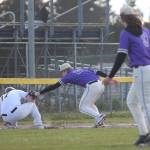 Noah Sorensen makes the tag at third base on Spartan Joey Hildebrandt, while NK teammate pitcher Dalton Brockett watches.