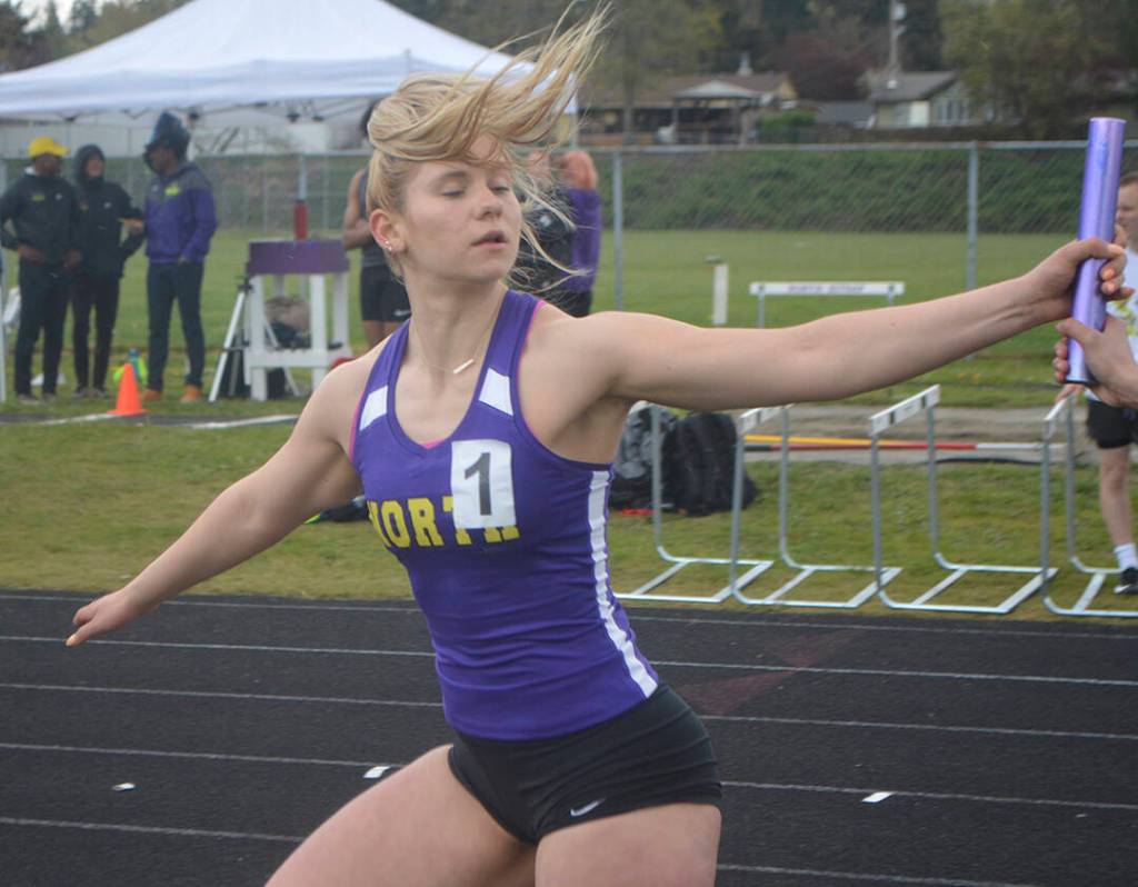 Lillian Pruden of NK takes the baton and came from way behind to win the 4 by 200 relay.