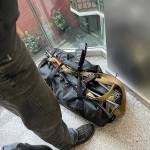 Signaling that Ukraine is in a state of war, an elevator passenger carries a rifle. (Courtesy photo)