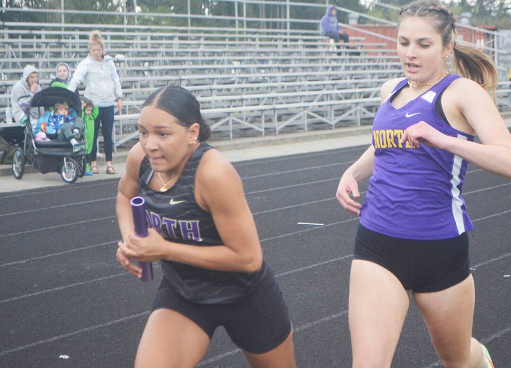 Viking Jasmine Gibson takes off after receiving the handoff from Emerson Bollert during a relay at a recent track meet.