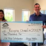 Regina Obnial (left), a graduating senior at South Kitsap High School, receives the fifth annual South Kitsap Community Pride Scholarship award from Doug Miller, owner and Realtor at South Kitsap Properties. The $2,000 award can be used for education expenses after high school. (Courtesy photo)