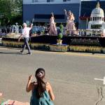 A little parade watcher exchanges a wave with a princess on a float. (Bob Smith | Kitsap News Group)