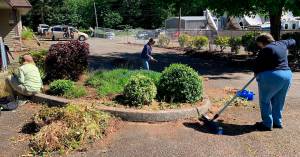 Volunteers clean up the property where the new homeless shelter is going. Courtesy Photo