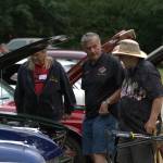 Classic car owners take a look at their vehicles.