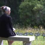 A woman sits at the indigent grave plot at Silverdale Pioneer Cemetery. Elisha Meyer/Port Orchard Independent Photos