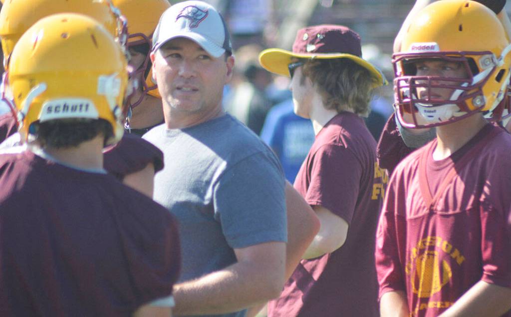 Kingston coach Billy Russo talks to his team during the huddle about what play to run.