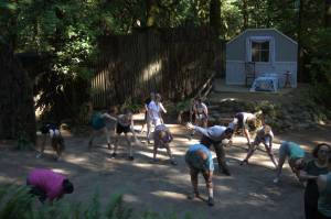 Performers warm up in the stage area prior to their dress rehearsal.