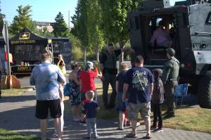 Families gather around a heavy-duty vehicle used by one of Kitsap Countys special units.