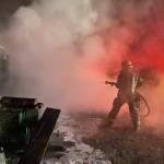 NKF&R firefighter/paramedic Janelle Randles fights a shed and dump truck fire near Hansville Tuesday night. Courtesy Photos