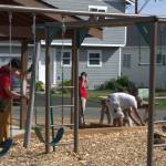 Volunteers continue to work on parts of a community playground.