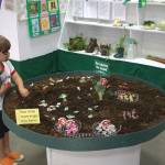 One of the kids entertains himself with the play farm exhibit.
