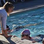 Klahowya swim coach Danielle Harding-Hanson teaches Alexia Cochran, Nevarg Glance and Kaiya Pasternak the ropes of competitive swimming.