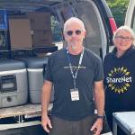 Volunteers Jim Johnsen and Susie Stevens staff ShareNet's Mobile Food Pantry. Courtesy Photo