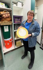 Jane Landry, head librarian for Sustainable Bainbridge Zero Waste Flatware Lending Library, shows off a plate from the collection of items available to community members. Nancy Treder/Kitsap News Group Photos