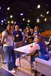 Sydney Sorensen of Bainbridge Island speaks with Julia Quinn during a book signing event in Poulsbo.