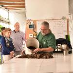 Mark Taylor shows visitors the process he uses to start plants in his hydroponics shed. Nancy Treder/Kitsap News Group Photos